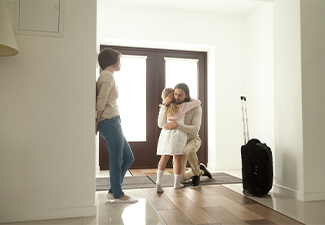 Little kid girl embracing dad leaving family moving out with travel case