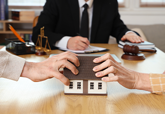 Mature couple dividing house at divorce lawyer's office, closeup