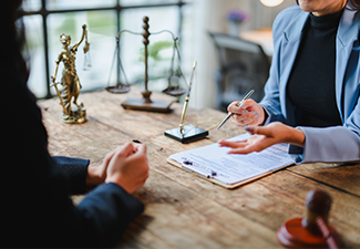 Lawyer explaining contract details to client during meeting in office