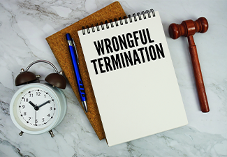 Wrongful Termination text written on notepad with pen and judge gavel