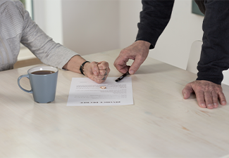 Couple with divorce document on table