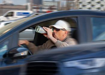 Man drinking liquor while driving