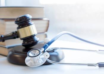 Gavel and Stethoscope in table