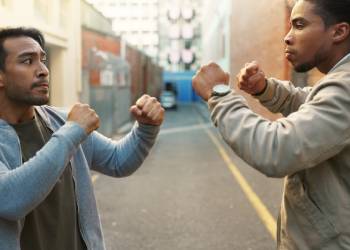 Two men with clenched fist ready for fight outdoors