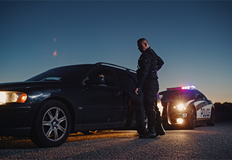 Cop Approaching a Pulled Over Car with Caution