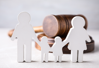 Figure in shape of people and wooden gavel on light table