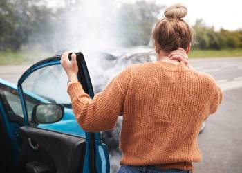 Women getting out of car after car crash