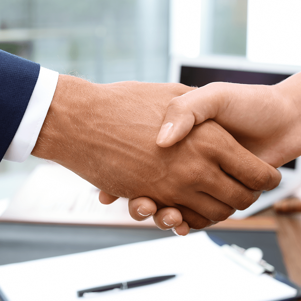 Male lawyer shaking hands with woman over table, closeup