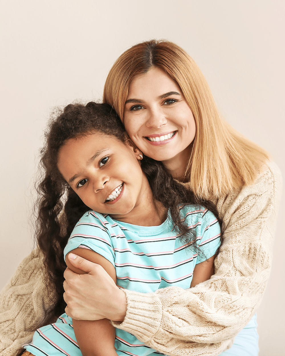 Happy woman with little adopted African-American girl on white background