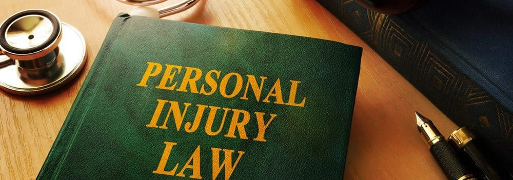 Personal Injury Law book with pen and stethoscope