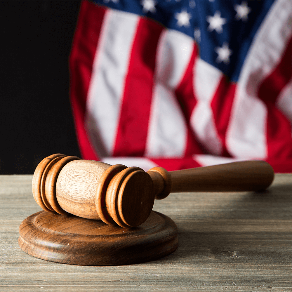 wooden judge on the desk with American flag