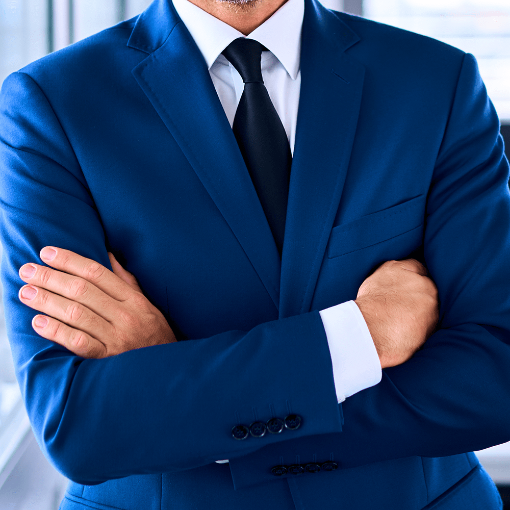 Portrait of successful businessman standing in corner office