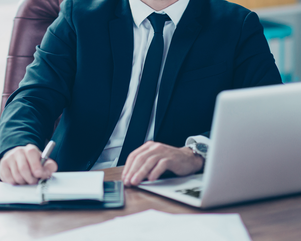confident owner of big company making notes to the notebook