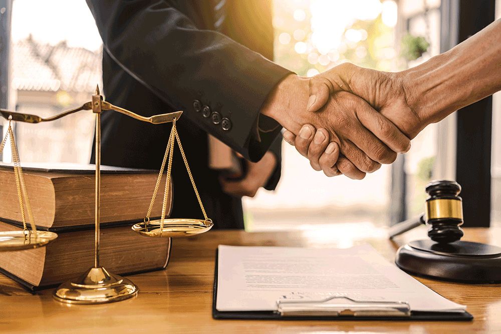 An attorney shaking a client's hands