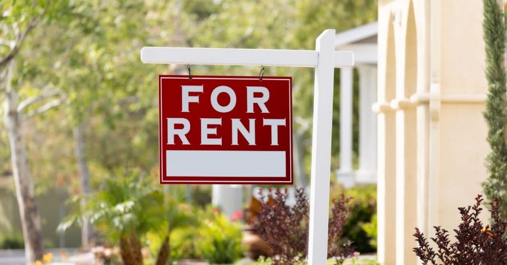 FOR RENT sign in the front yard of a home