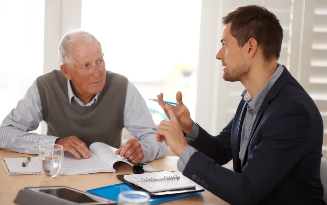 Senior Citizen talking to a man in a suit