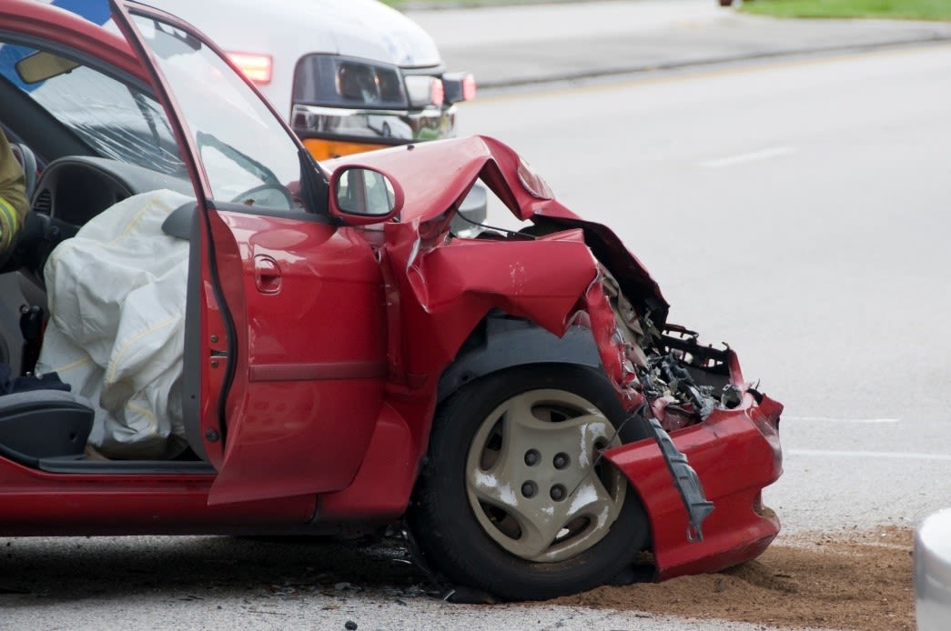 damaged red car