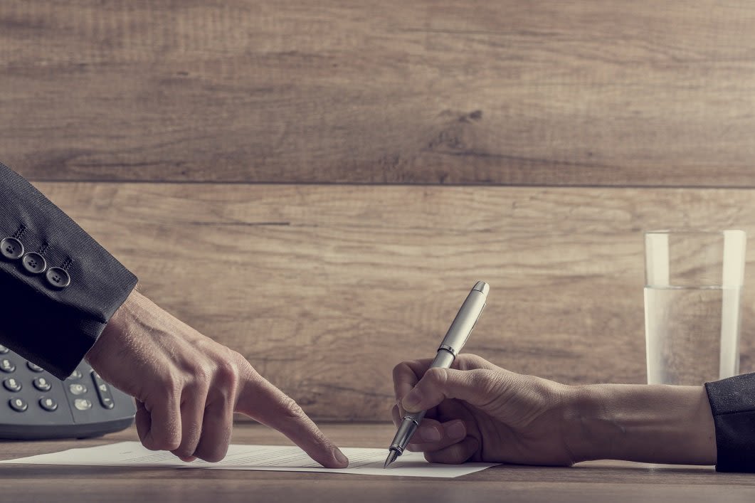 People Signing a Paper