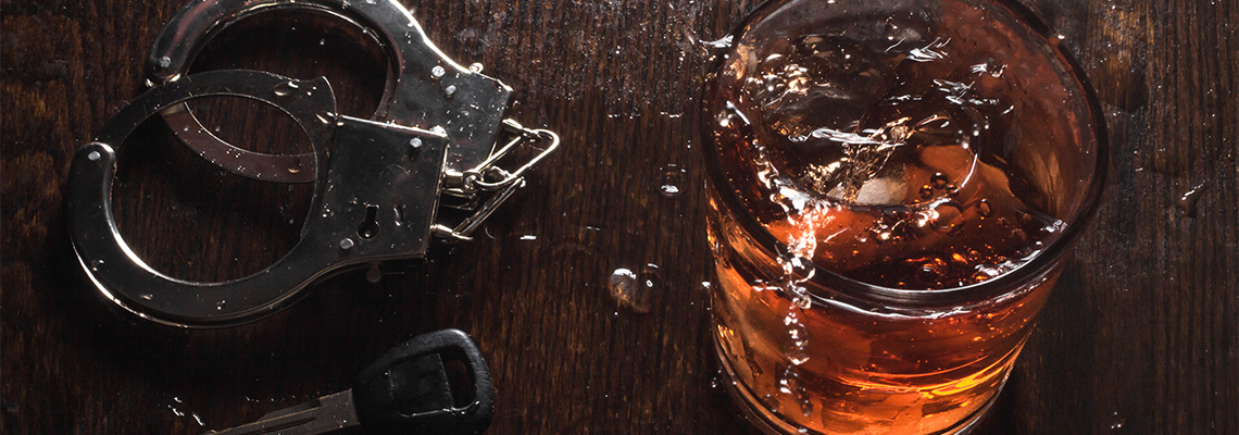 Alcohol Keys Handcuffs on a Table