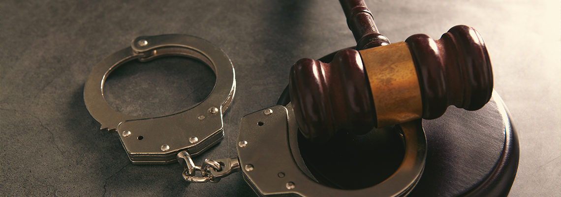 Law theme, mallet of judge, wooden gavel and handcuffs