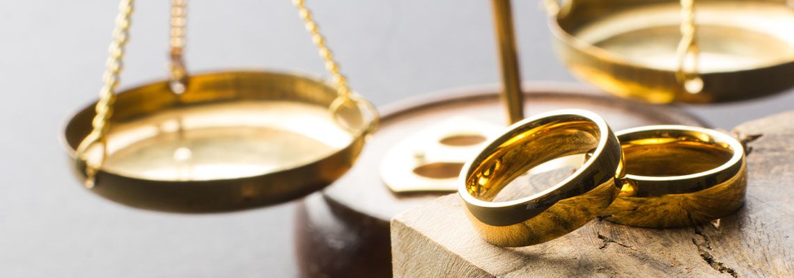 Two golden wedding rings, judge gavel.
