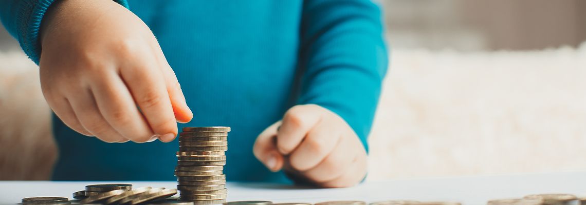 Child with stack of coins