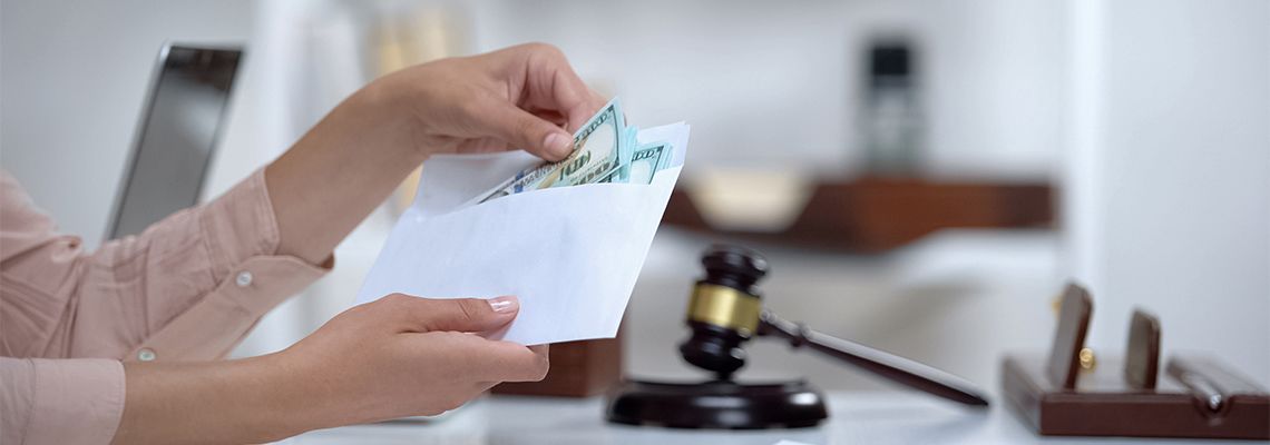 Divorced woman holding envelope with dollars