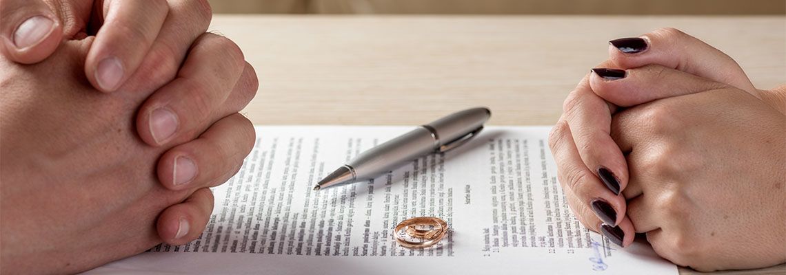 Wife and husband signing divorce documents