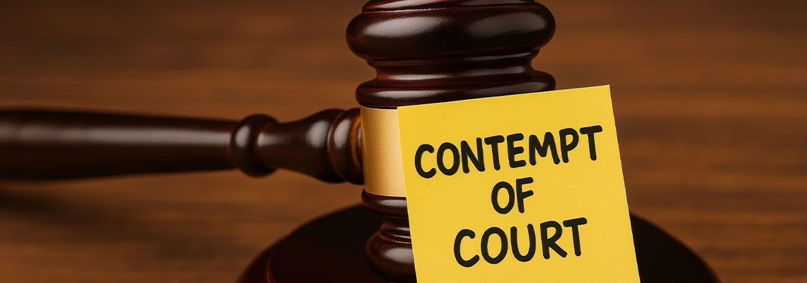 Contempt of court word on note with gavel on table