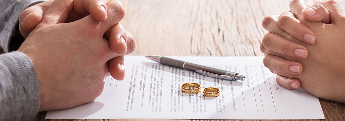 Couples signing divorce agreement paper