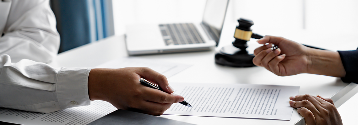 Serious courtroom lawyer preparing litigation documents for business client