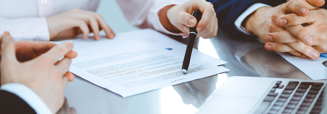 Group of business people and lawyers discussing contract papers