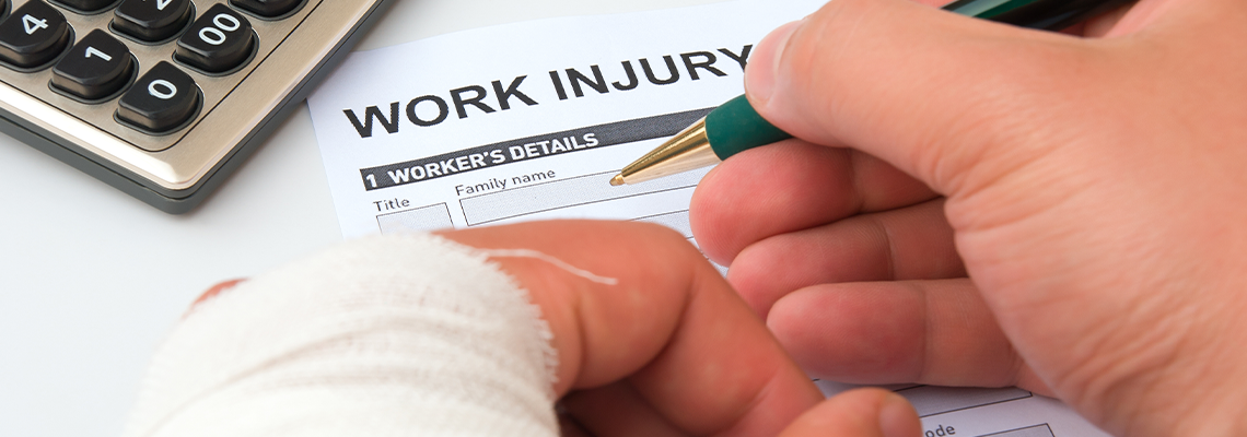 Person with a cast filling out A Work Injury Claim Form