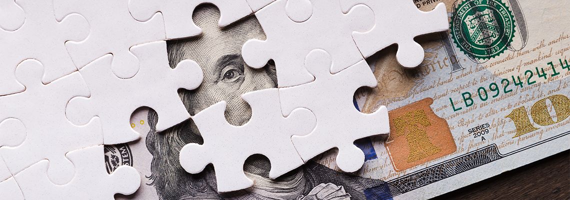 American dollar hidden under puzzle pieces