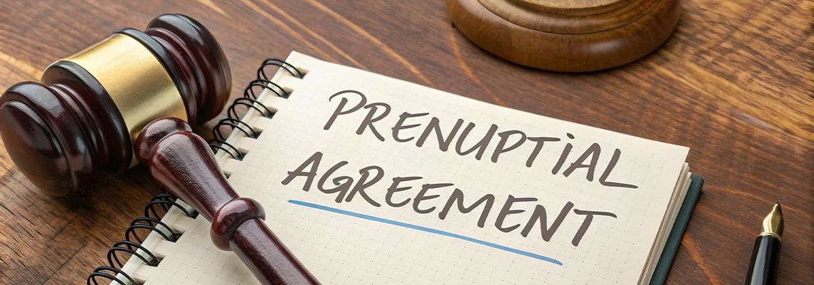 'Prenuptial Agreement' written in a notebook with gavel