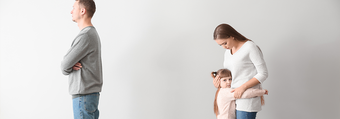 Unhappy family after quarrel against light wall