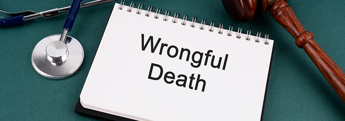 High angle view of Gavel and Wrongful Death text on a Notebook