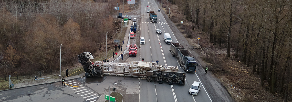 Aerial view of road accident with overturned truck blocking traffic