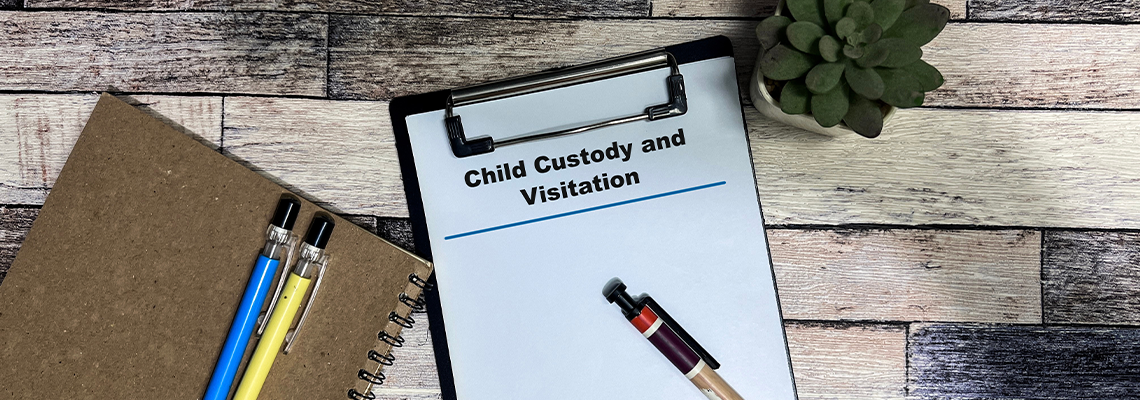 Concept of Child Custody and Visitation write on paperwork isolated on Wooden Table