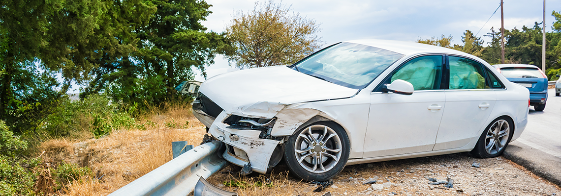 Crashed car with deflated airbags after accident finished on road crashed barrier