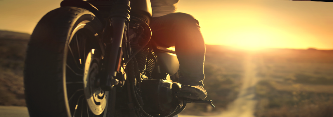 On a roaring motorcycle at sunset