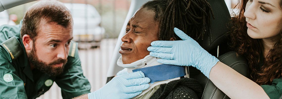 Paramedic treating injured woman from car accident