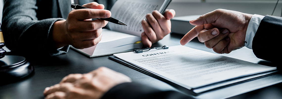 Close up of businessmen or lawyers discussing contract or business agreement.