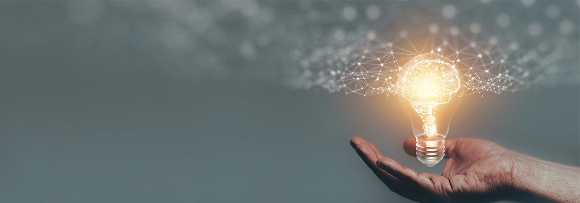 Hand holding Bulb with glowing brain, Intellectual property concept