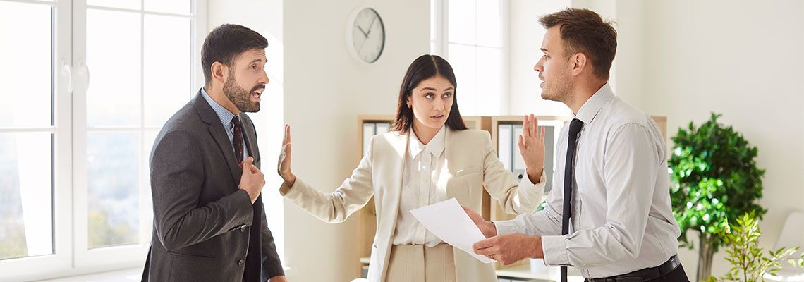 Attorney trying to calm down two angry businessmen
