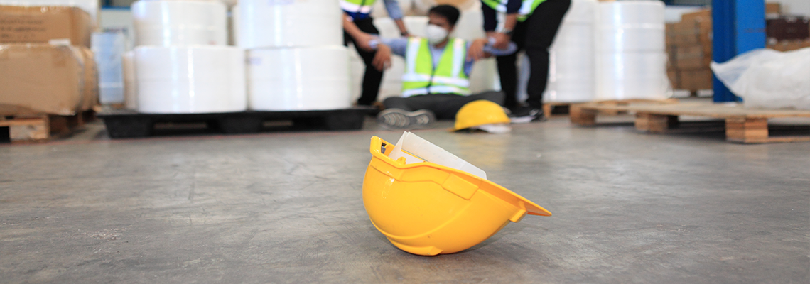 Person on ground surrounded by others in warehouse