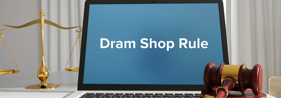 A lawyer laptop in the office on desk with text "Dram Shop Rule"