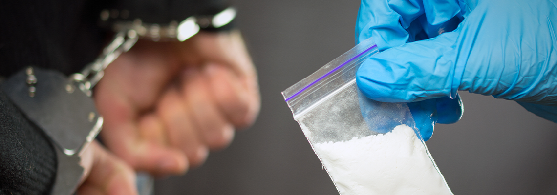 A police officer finds drugs during the search of drug dealers