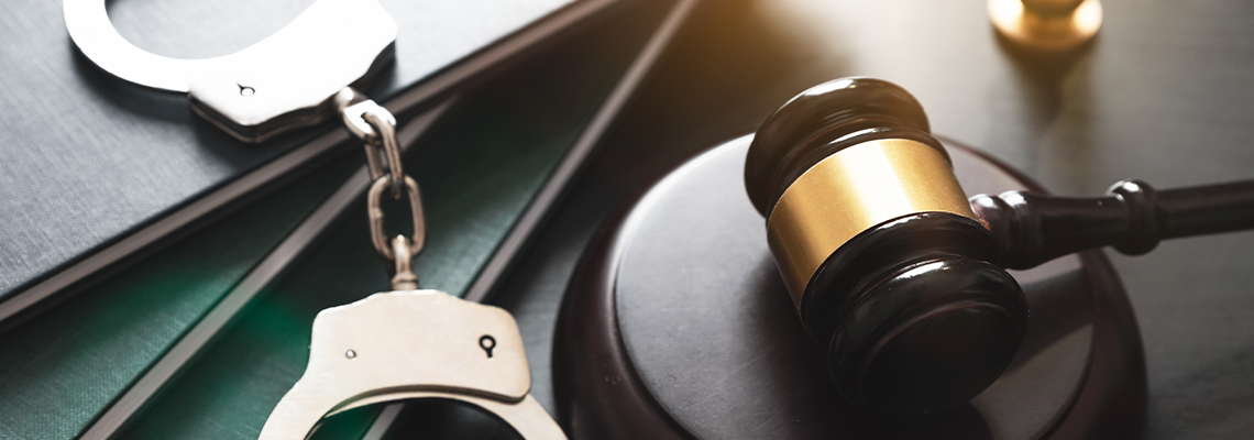 Crime and violence concept with handcuffs and gavel