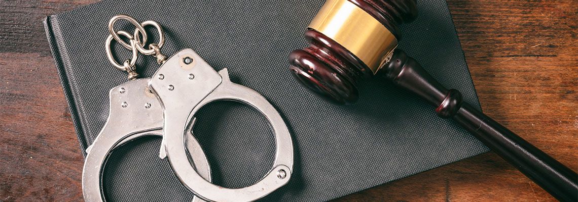 Gavel and handcuff in table
